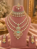 Mint green kundan bridal set with choker, 3-line long haar, earrings and maang tikka on a mannequin