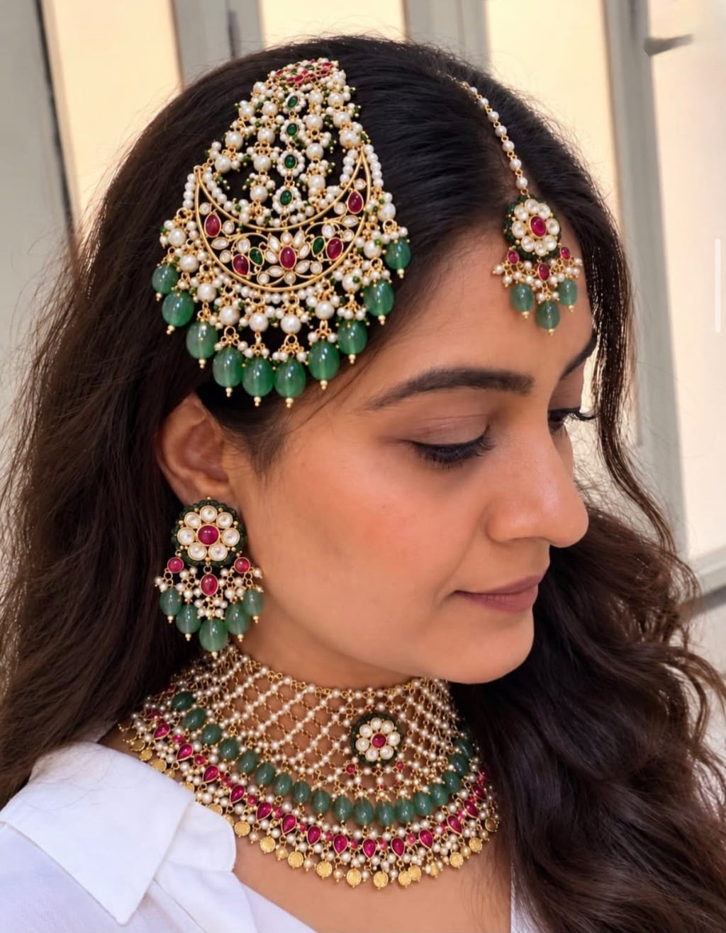 Nizami Emerald-Ruby Bridal Set worn by model - pearl choker, passa, earrings and maang tikka with emerald green beads and ruby stones