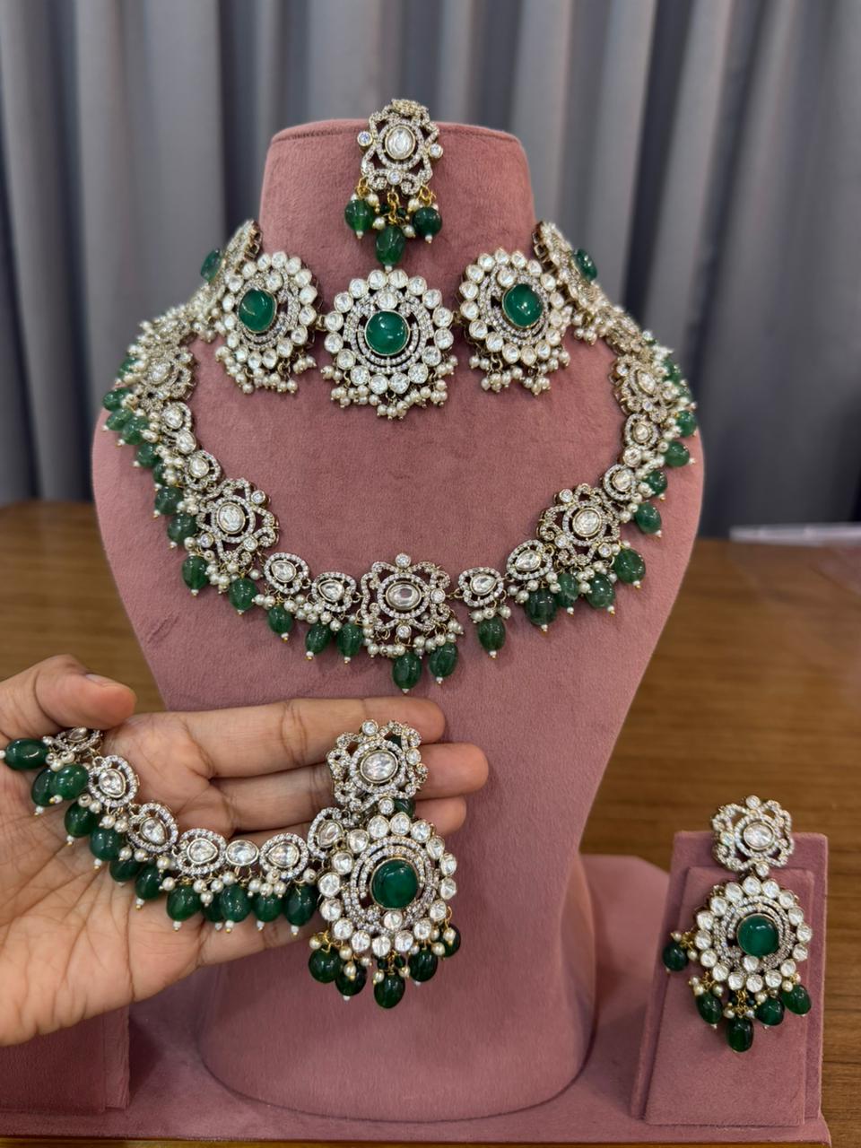 Emerald green polki bridal jewellery set close-up showing oval cabochon stones, pearl drops and antique gold-tone setting - handcrafted Kundan choker for Indian brides