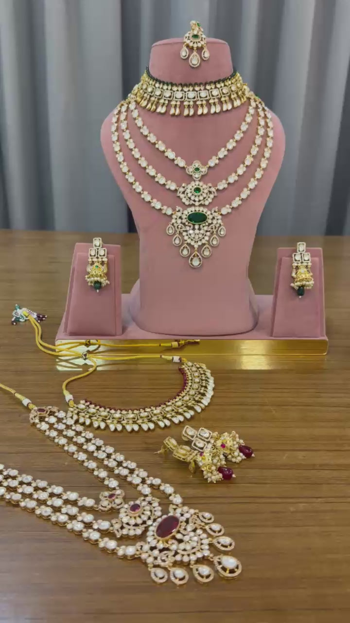 Video of the emerald green and ruby red kundan bridal sets with choker, 3-line long haar, earrings and maang tikka