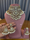 Ornate necklace and earrings set on a mannequin bust with a blurred background