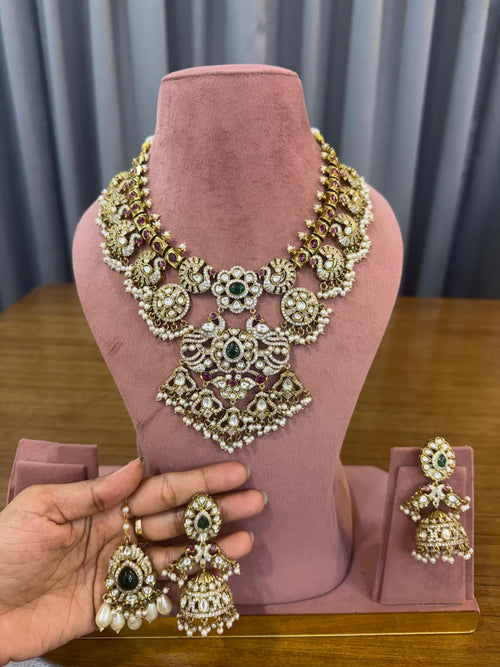 Bridal Kundan and Polki jewellery set with green and ruby stones, choker, long necklace and earrings