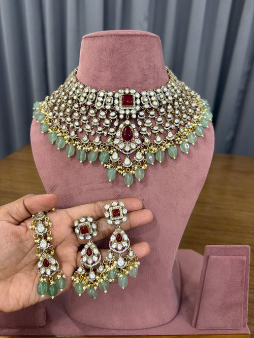 Ganesh Kundan and Polki bridal choker set with ruby red stones and mint green beads for Indian brides.