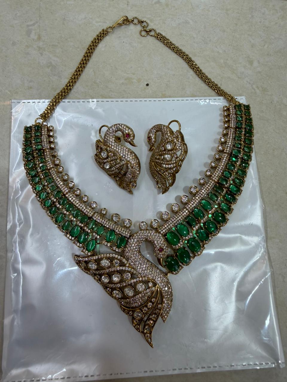 Bridal Kundan Polki jewellery set with emerald green stones choker and long necklace