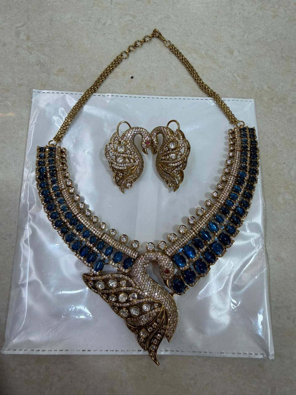 Blue bridal kundan polki jewellery set with choker and peacock pendant